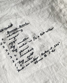 Embroidered handwritten recipe on white cloth kitchen towel