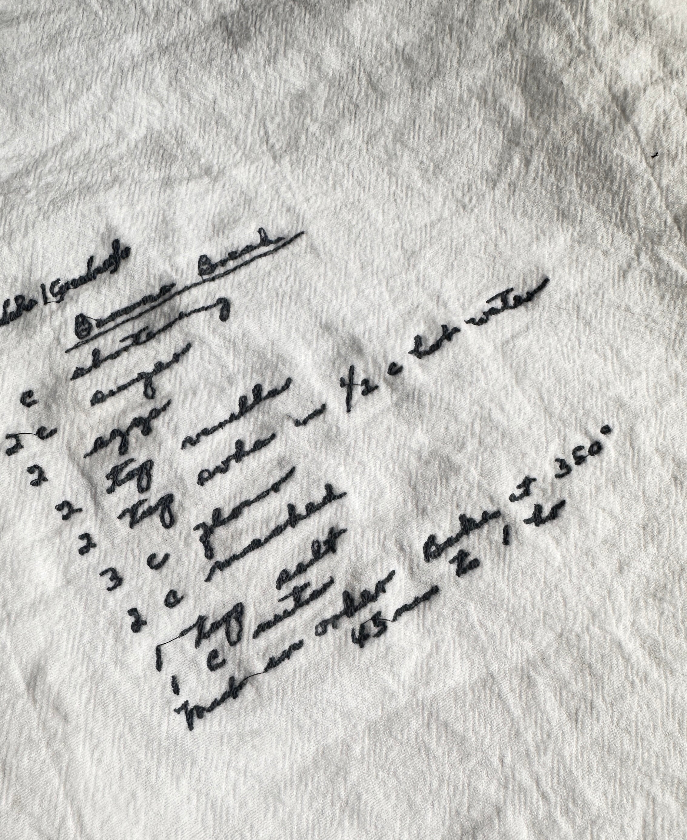 Embroidered handwritten recipe on white cloth kitchen towel